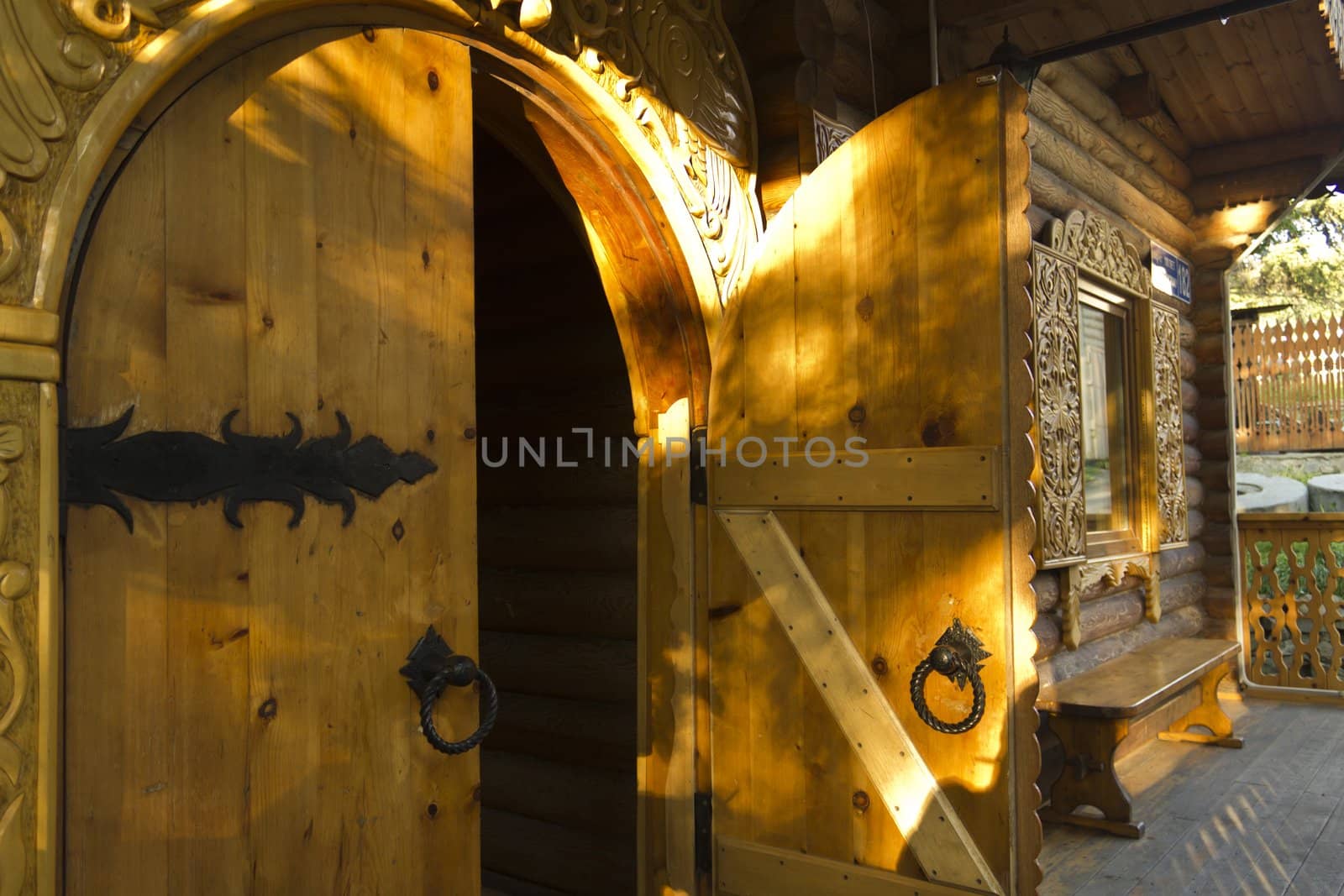 Wooden open door in Russian log hut