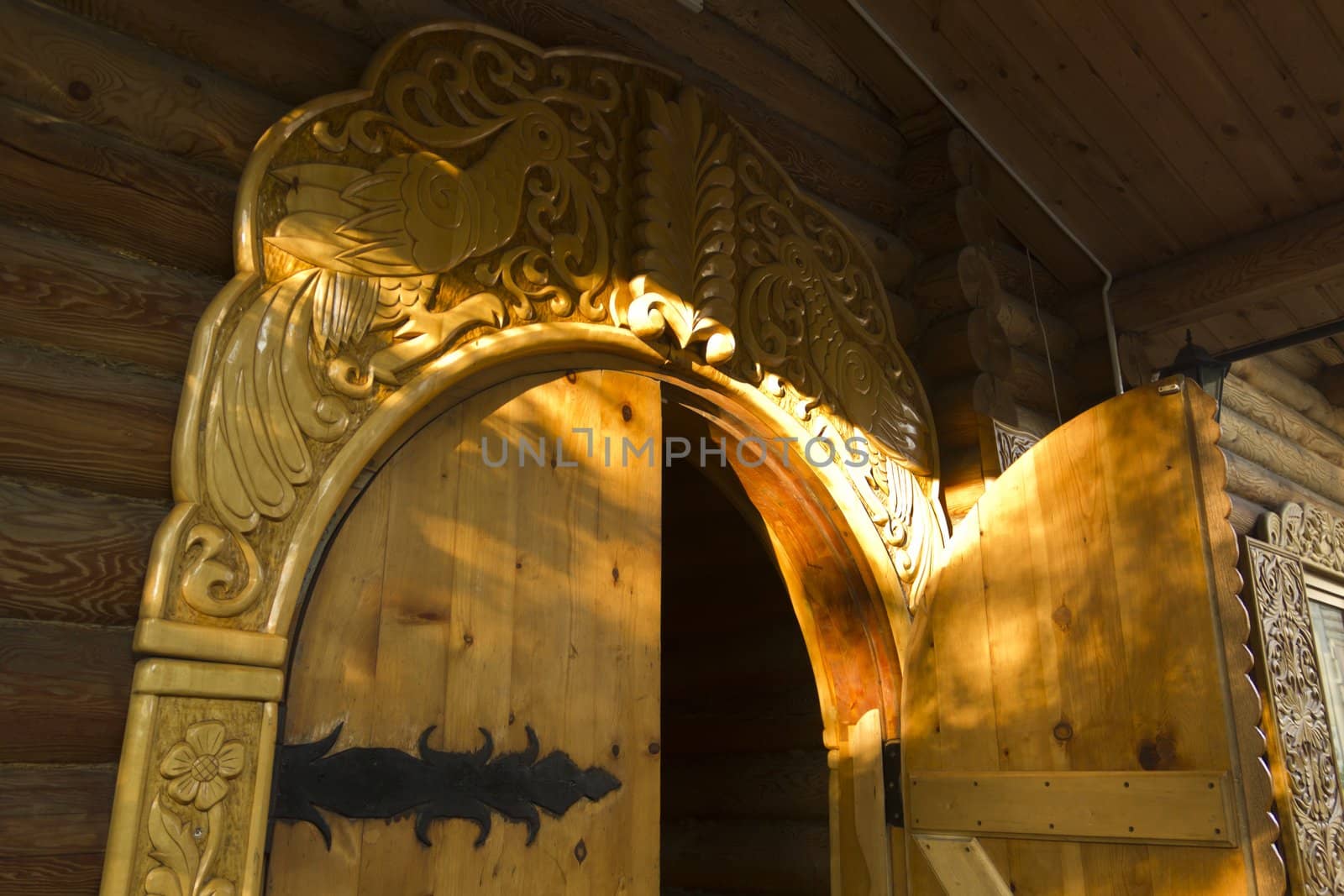 Wooden open door in Russian log hut