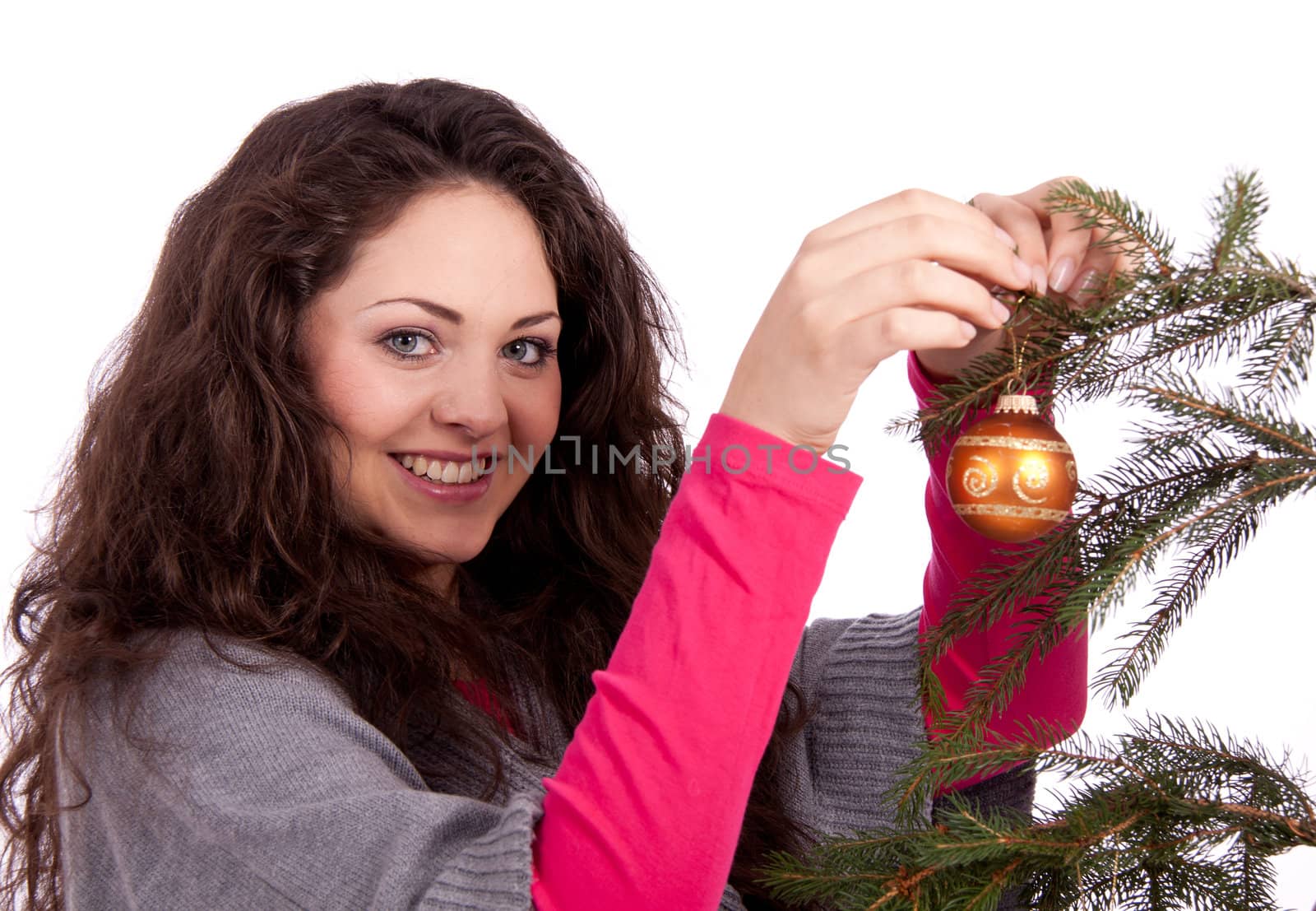 beautiful brunette woman is decorating a christmas tree isolated on white