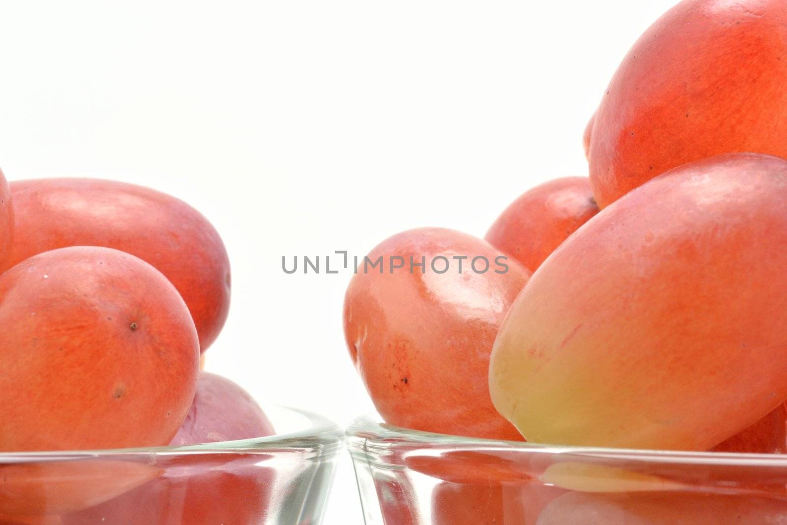 Red grape over white by Autre