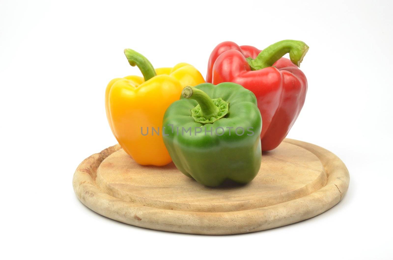 Fresh colorful paprika on wood block