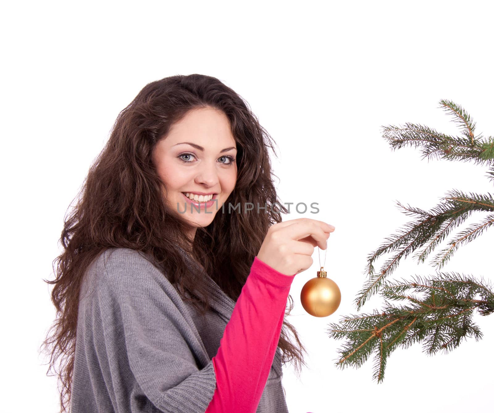 beautiful brunette woman is decorating a christmas tree isolated on white