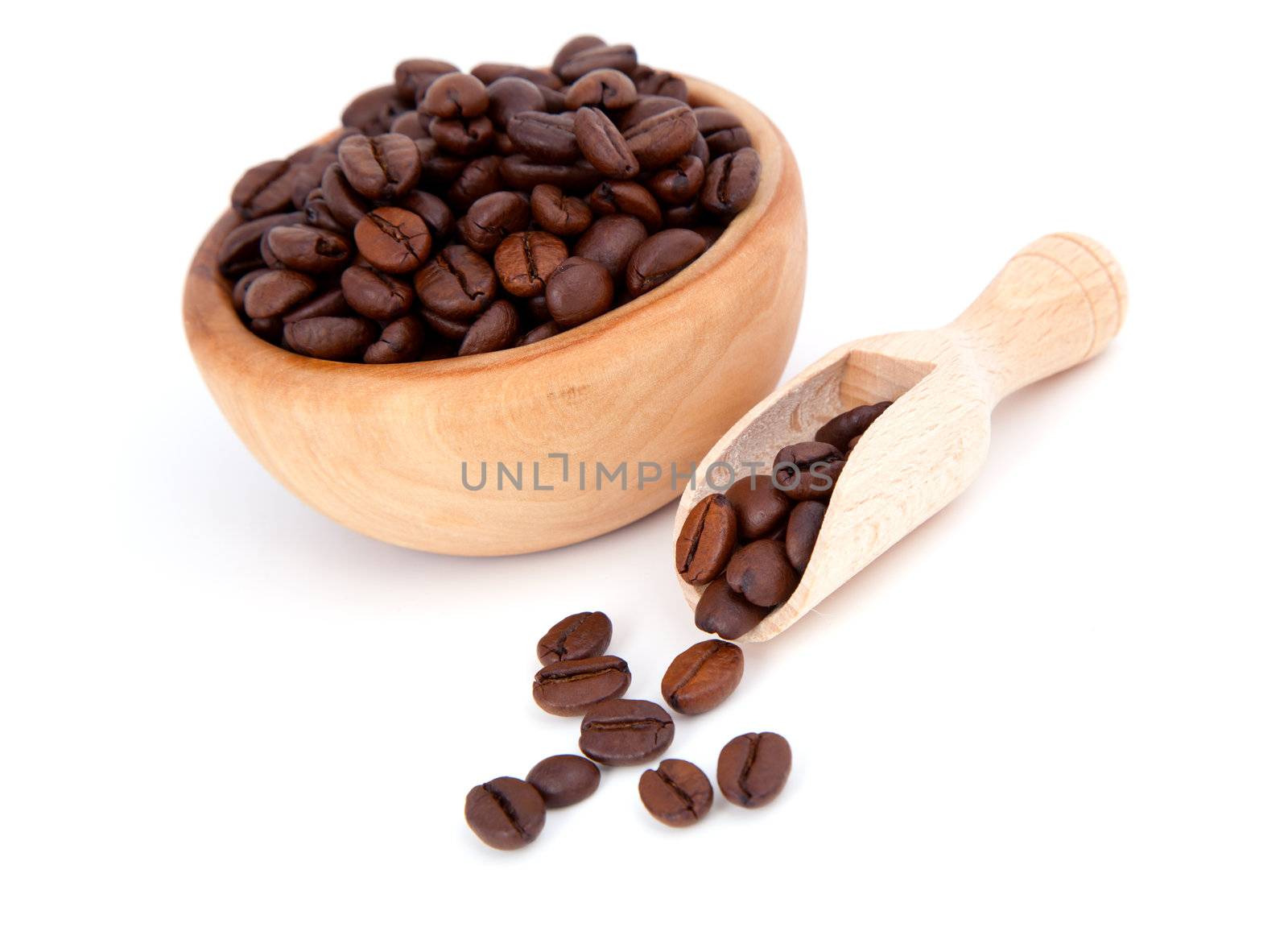 coffee beans in the wooden spoon, isolated on white background
