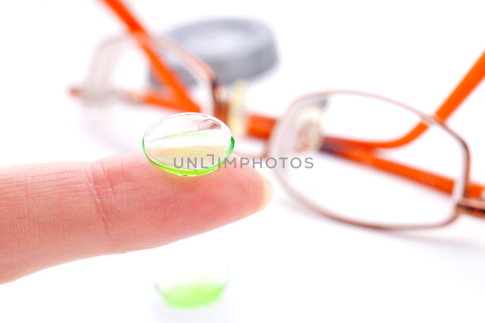 Contact lens on finger,  isolated on white background
