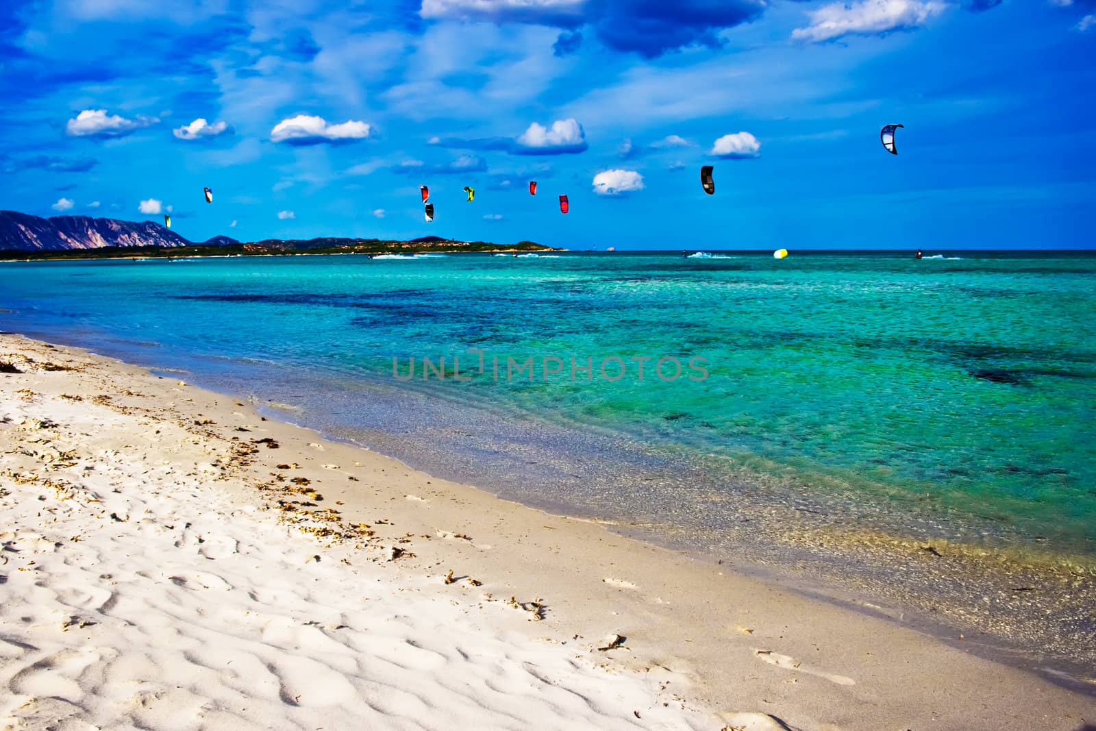Kitesurfers in the Tyrrhenian Sea near la Cinta beach, Sardinia, Italy