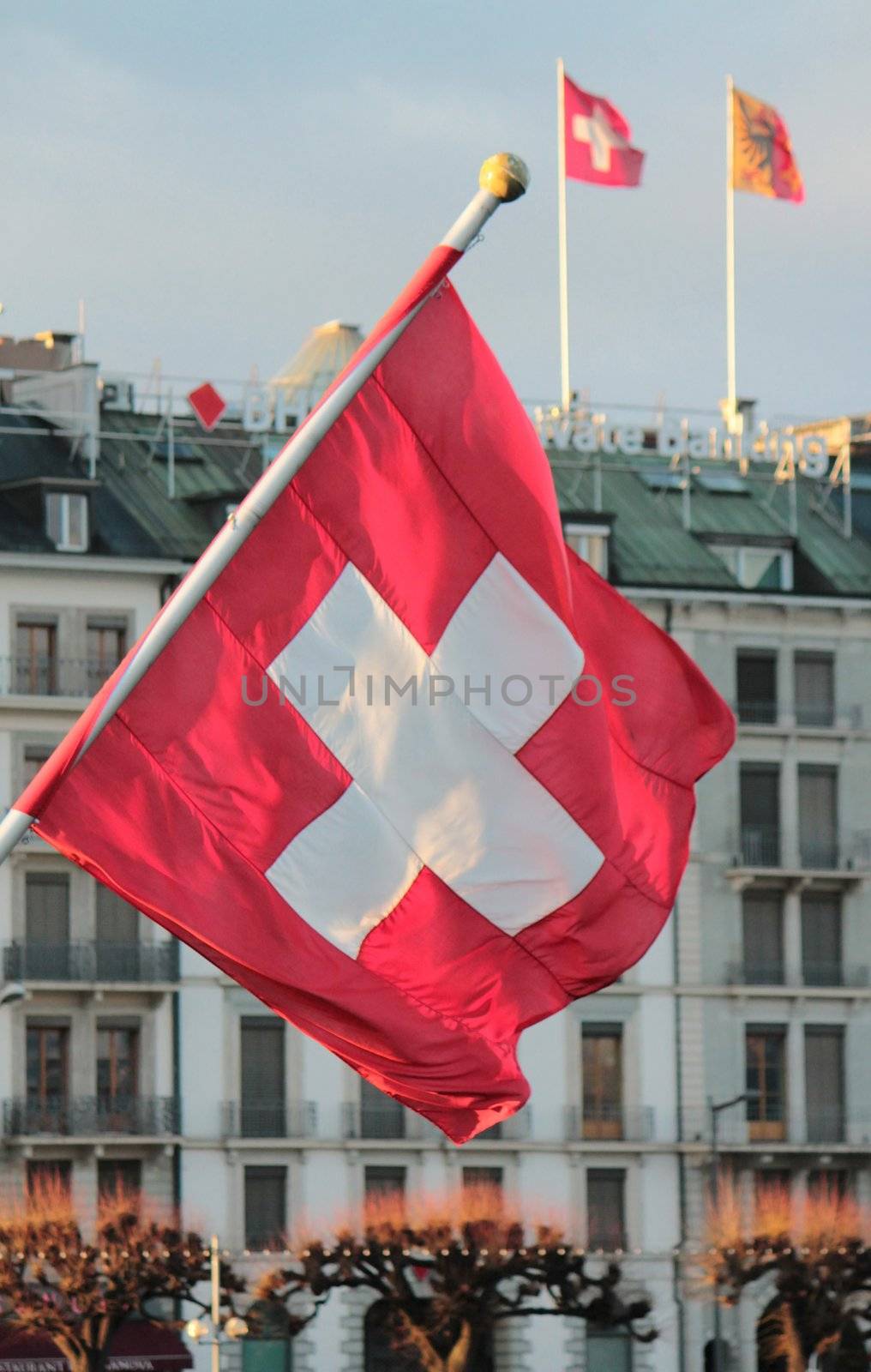 Swiss flag in front of Geneva building, Switzerland