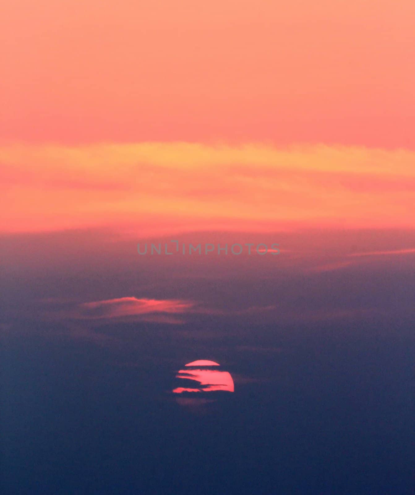 Beautiful colorful sunset behind tes clouds, Santorini, Greece