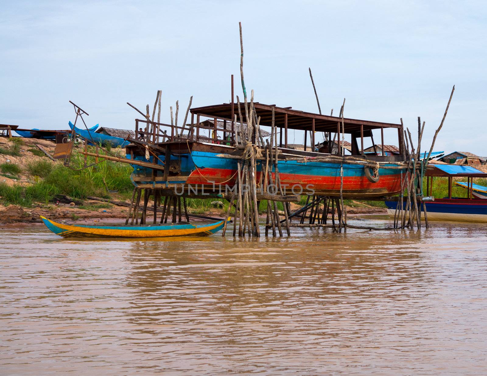 Floating village on Lake Tonle Sap in Cambodia with some houses made from boats