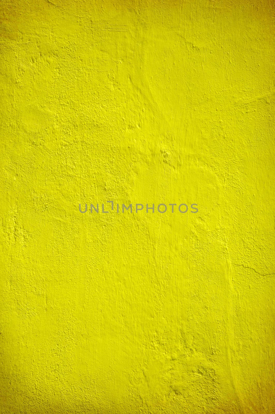 Plastered yellow green wall in closeup