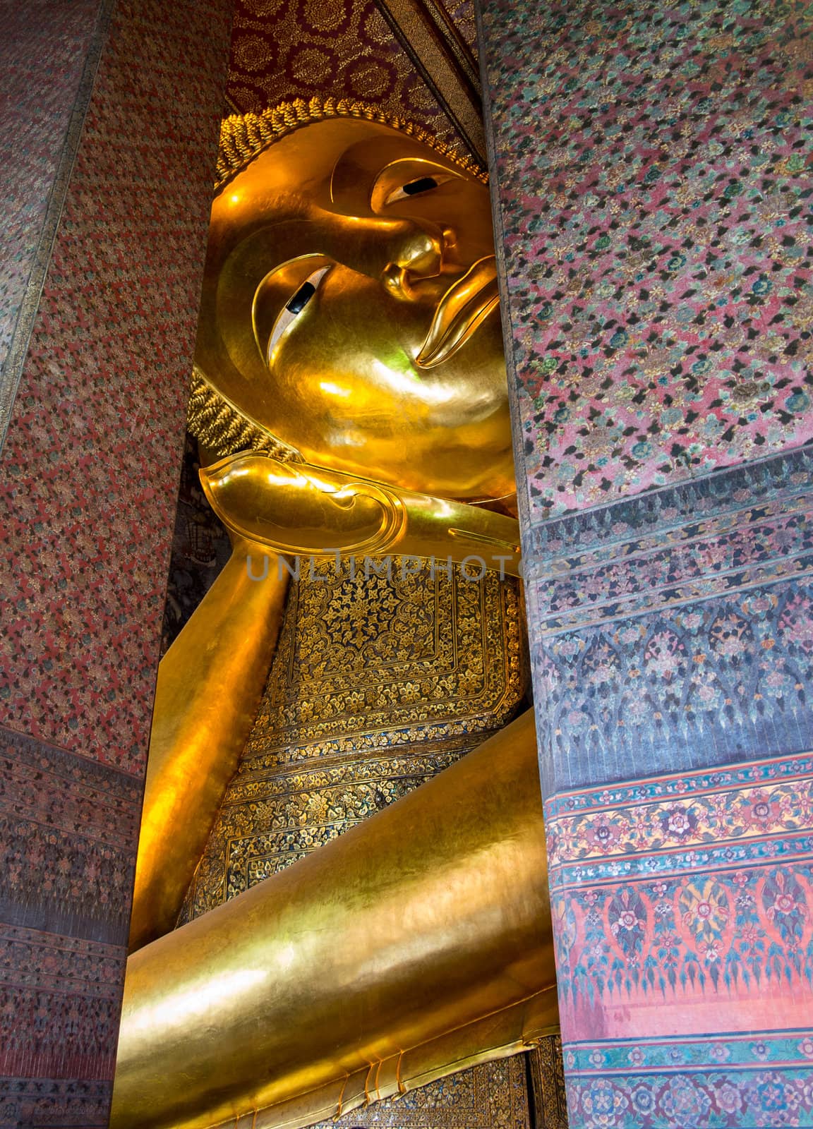 Detail of head and arm of reclining Buddha in Wat Po Temple in Thailand