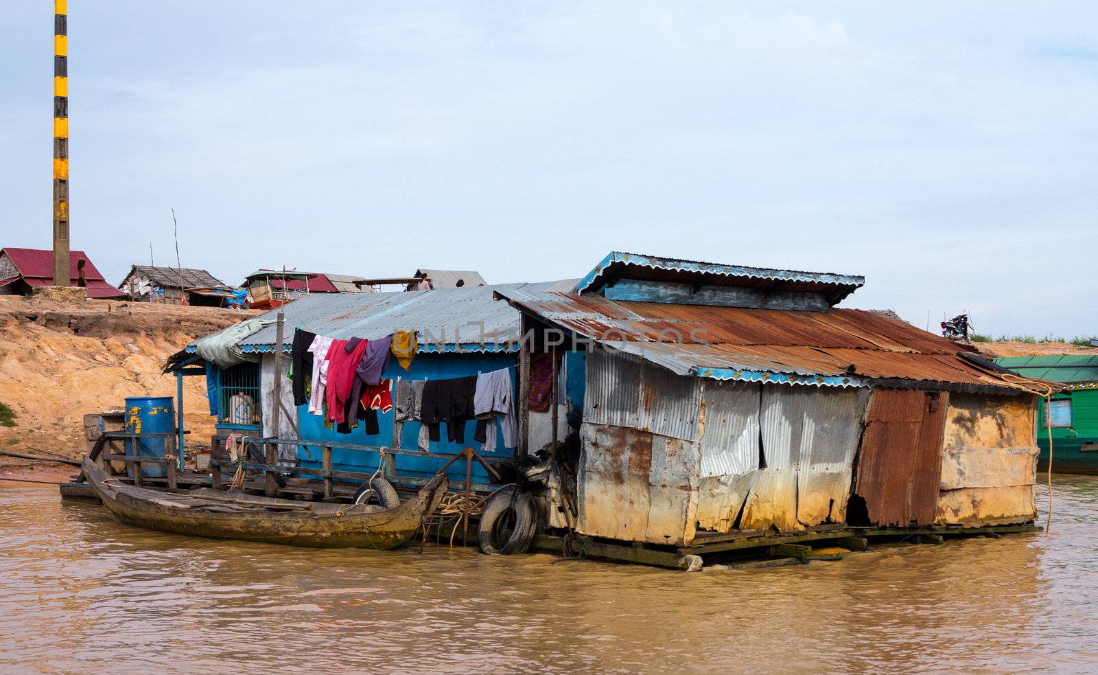 Floating village on Lake Tonle Sap in Cambodia with some houses made from boats