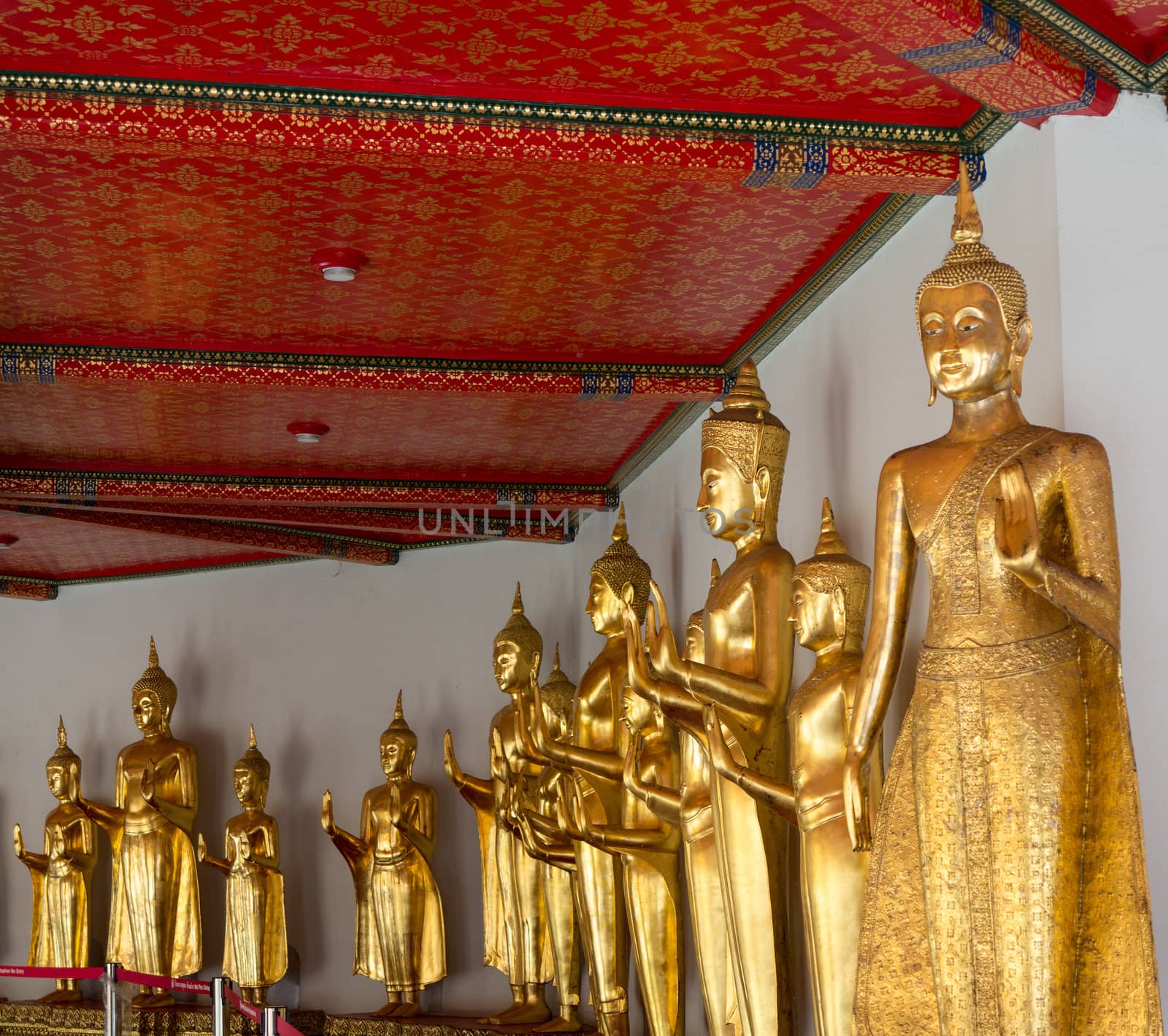 Many golden buddha statues in Wat Po temple near Bangkok in Thailand