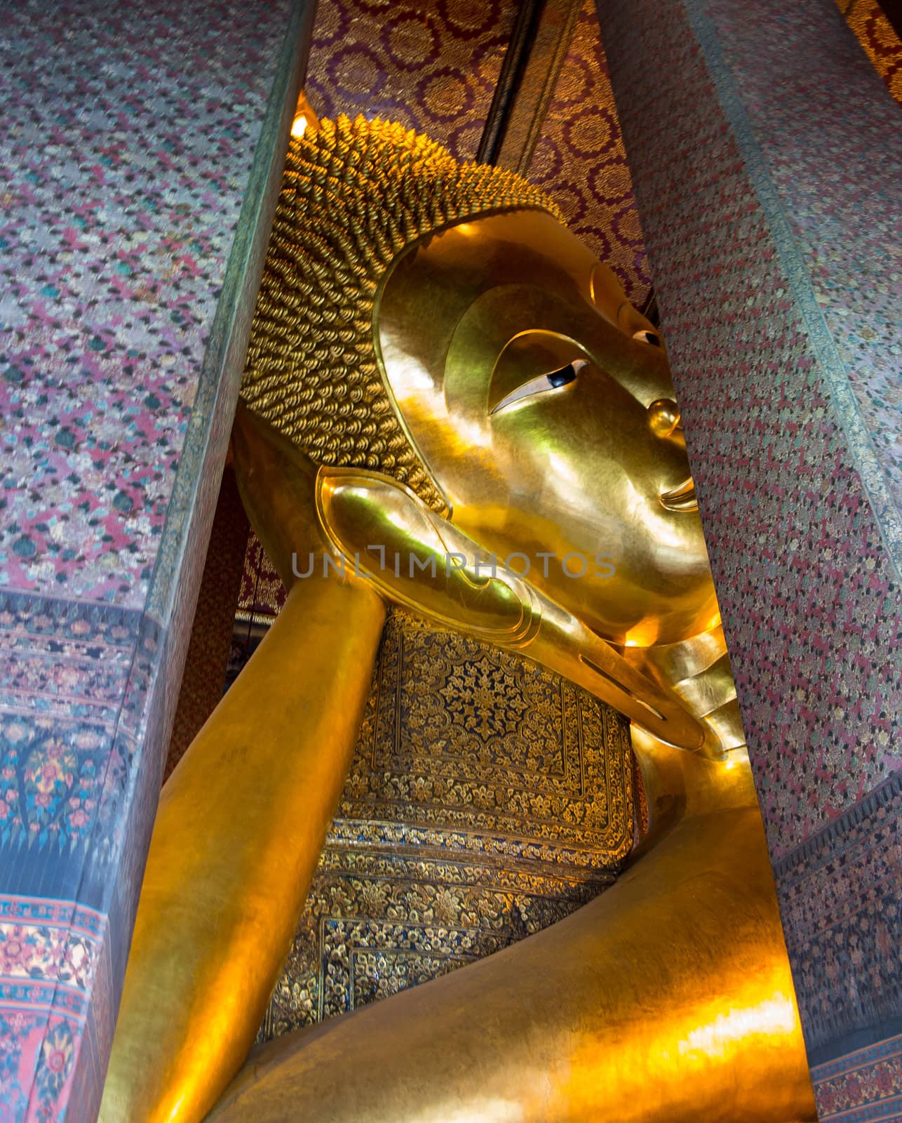 Detail of head and arm of reclining Buddha in Wat Po Temple in Thailand