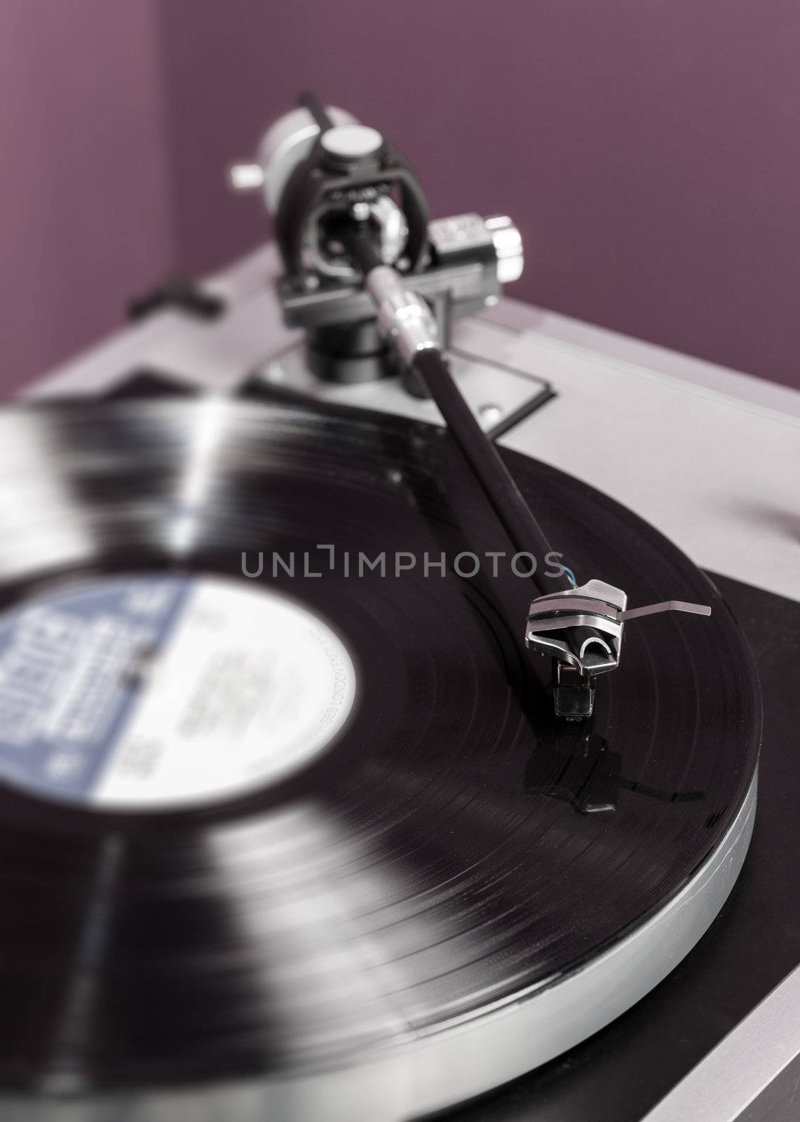 Long Playing record LP on retro record player with tone arm and cartridge