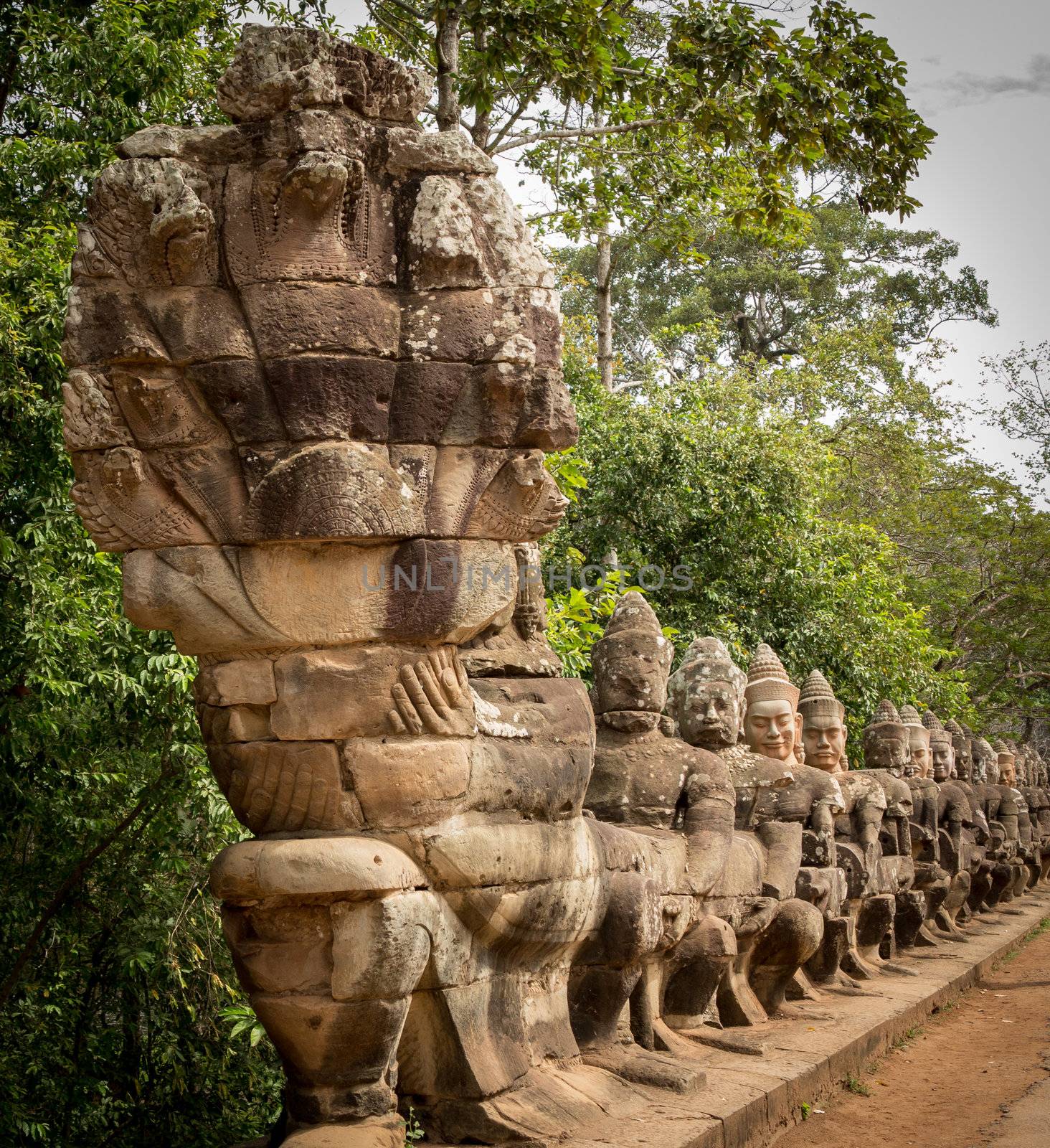 South gate to angkor thom in Cambodia is lined with warriors and demons