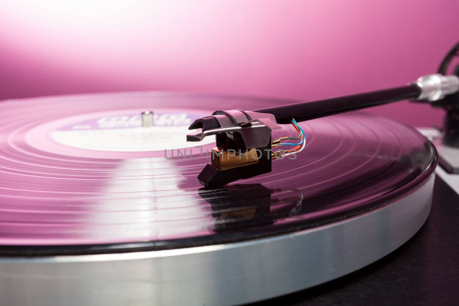 Long Playing record LP on retro record player with tone arm and cartridge