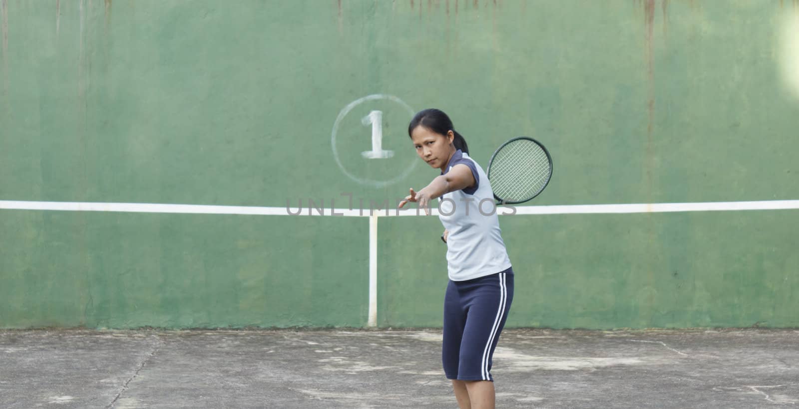 Female tennis player getting ready to hit forehand stroke