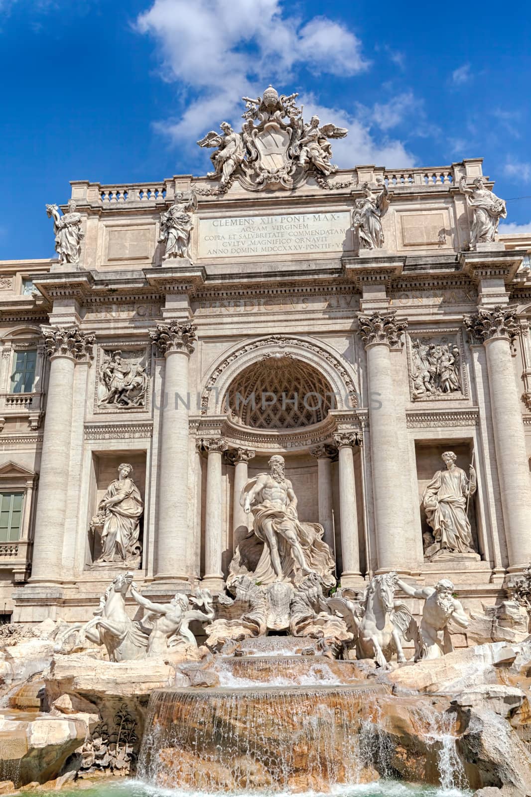 Trevi's fountain in Rome with bly sky and clouds