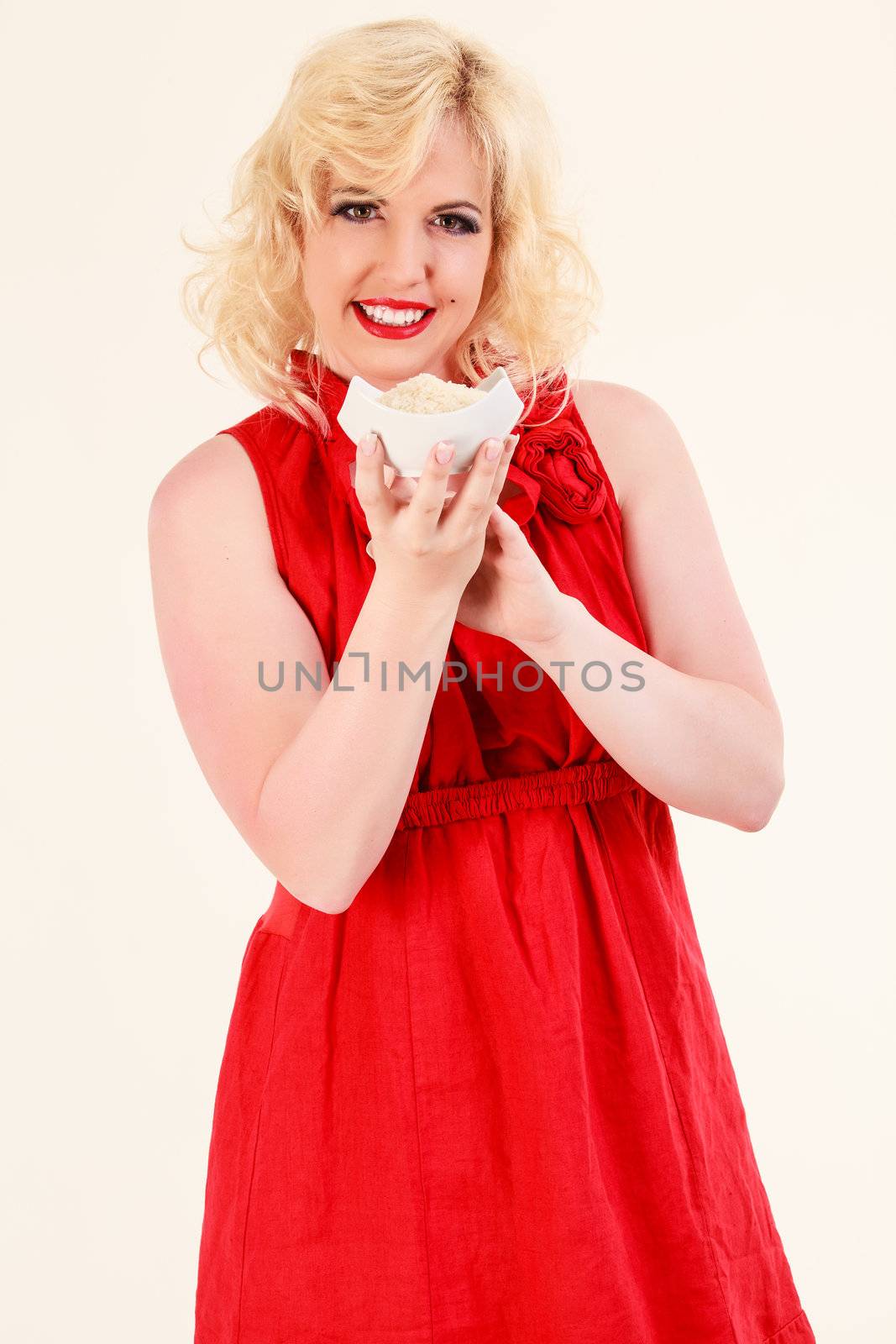 Blonde woman holding a bowl of rice in the hands