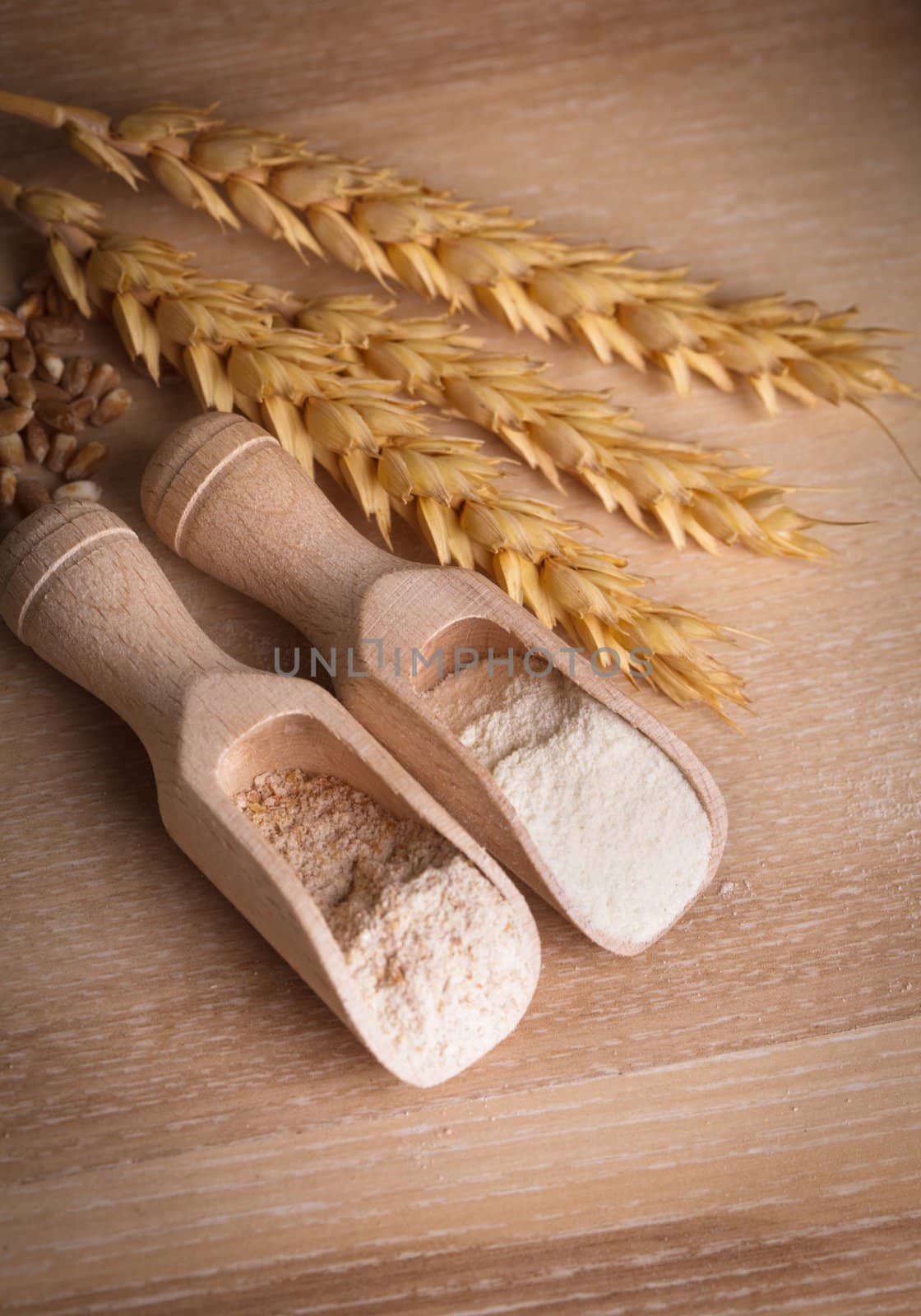 Meal and flour in the wooden spoon closeup