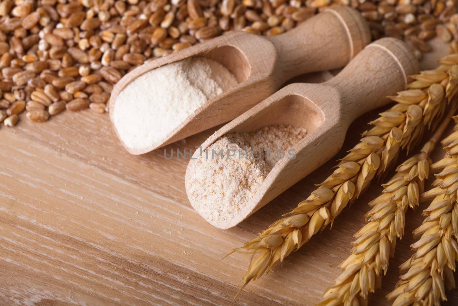 Meal and flour in the wooden spoon closeup