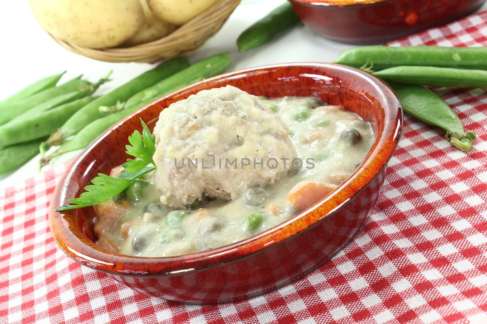 delicious fresh cooked meatballs in a white sauce with capers, potatoes and parsley