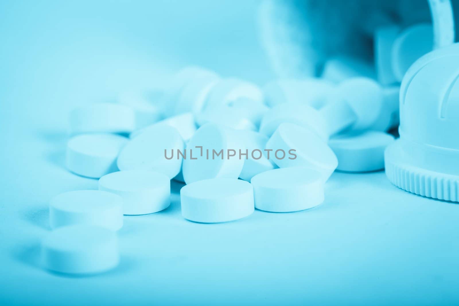 White medicine pills scattered on the table