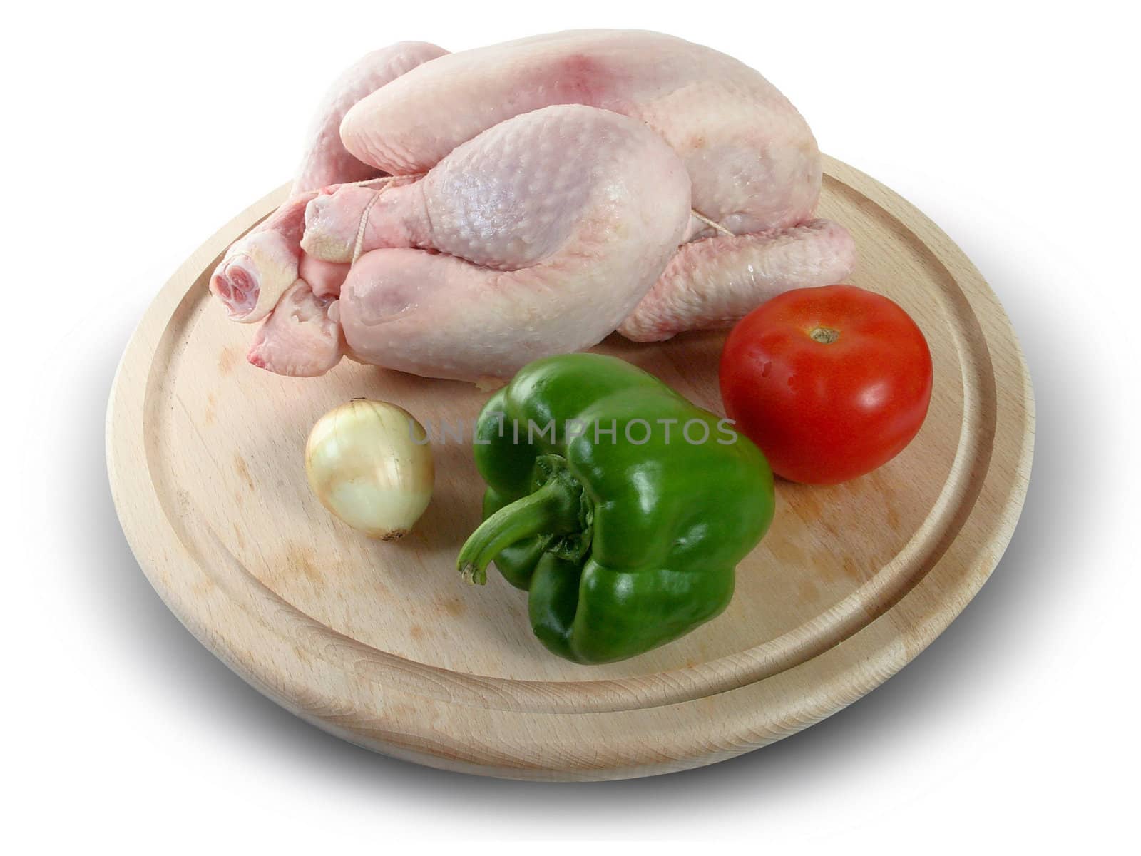 Whole raw chicken with vegetables and pepper by Baltus