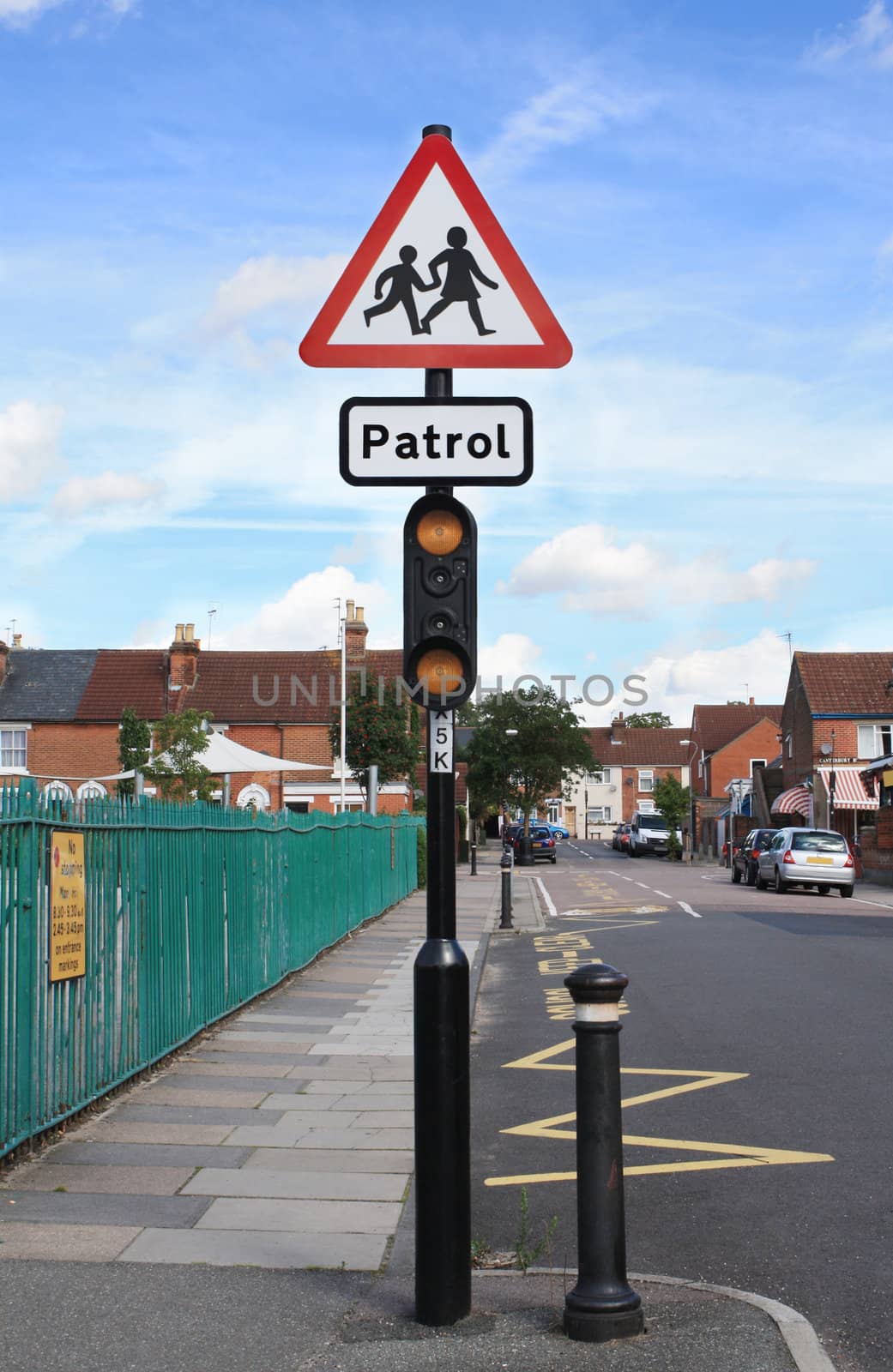 School and school patrol warning traffic sign in a street in England.