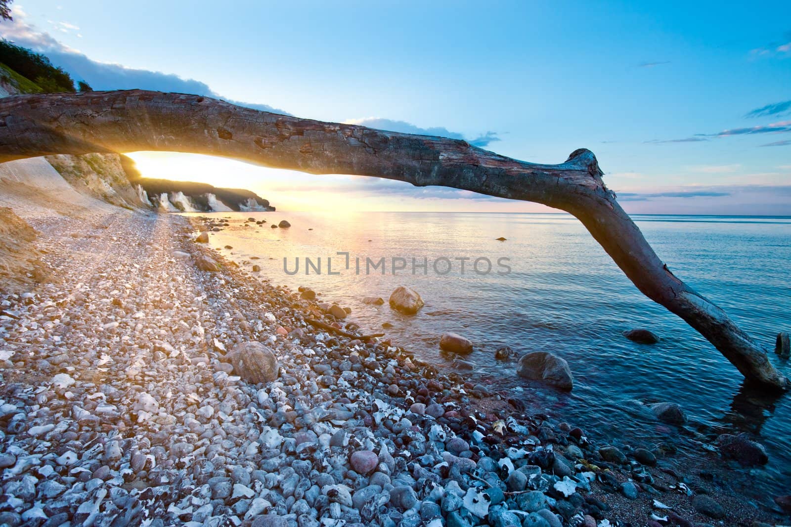 sunset at rocky beach by filmstroem