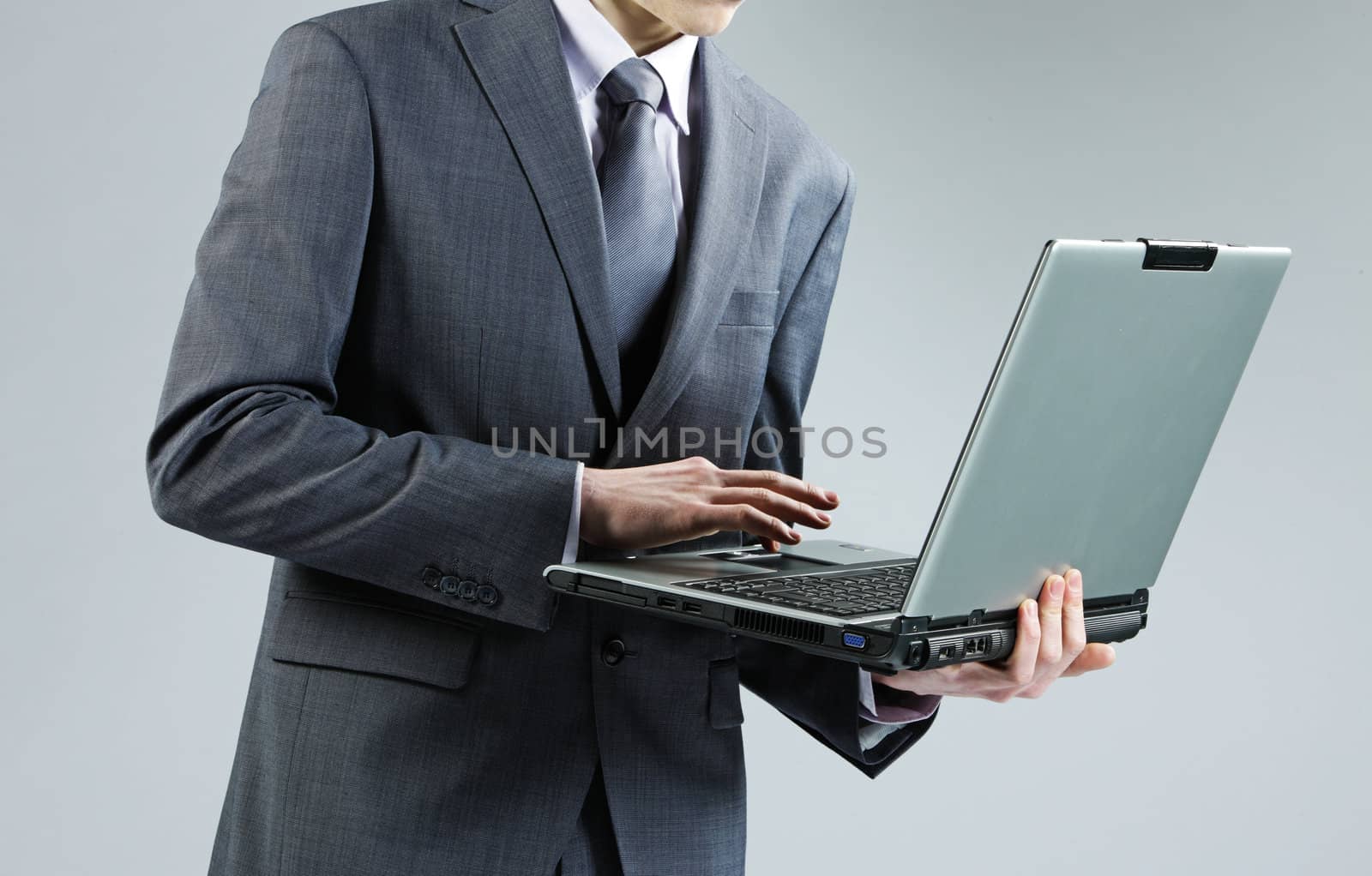 Businessman with Laptop by stokkete