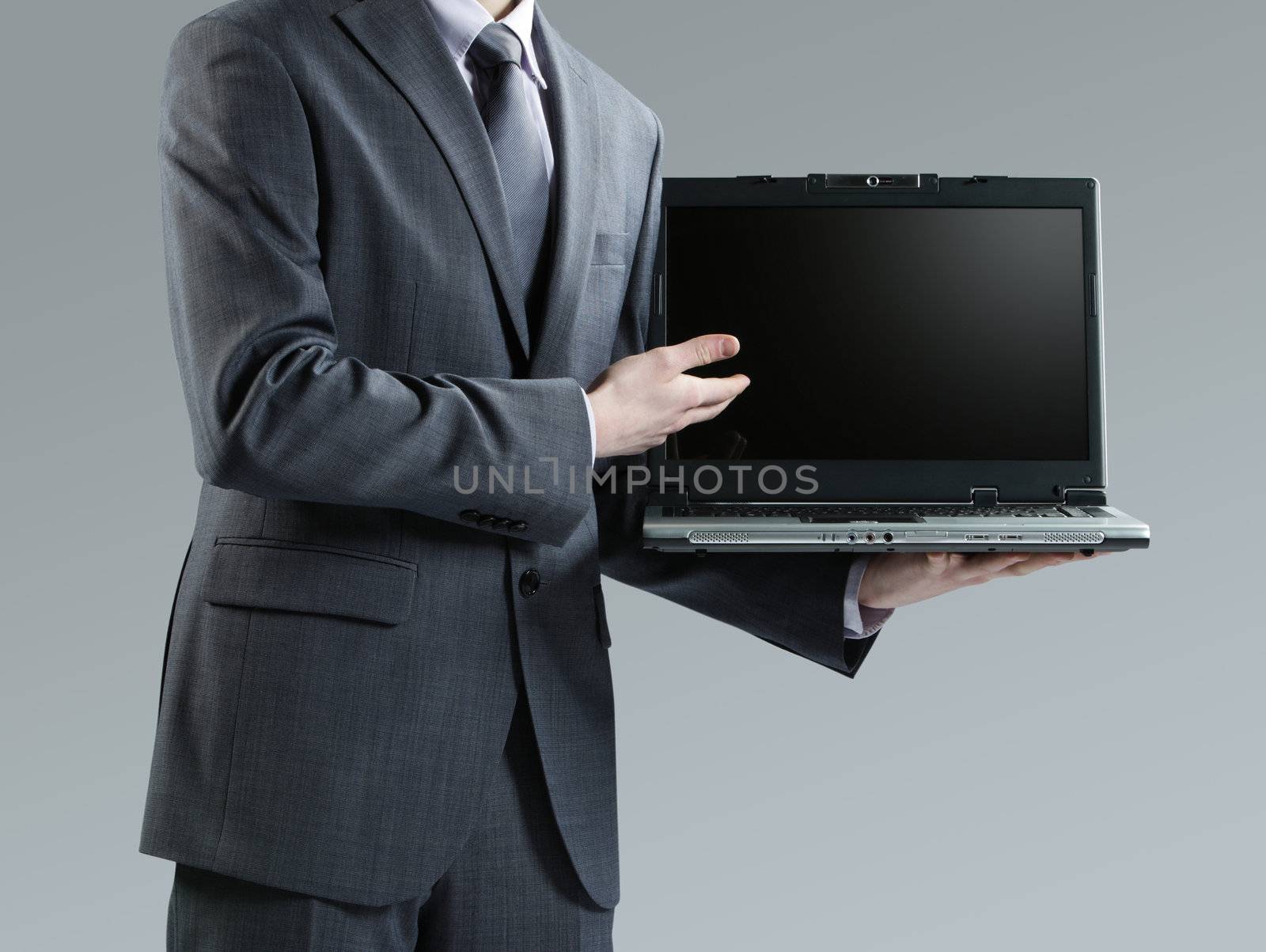 Businessman holding his laptop