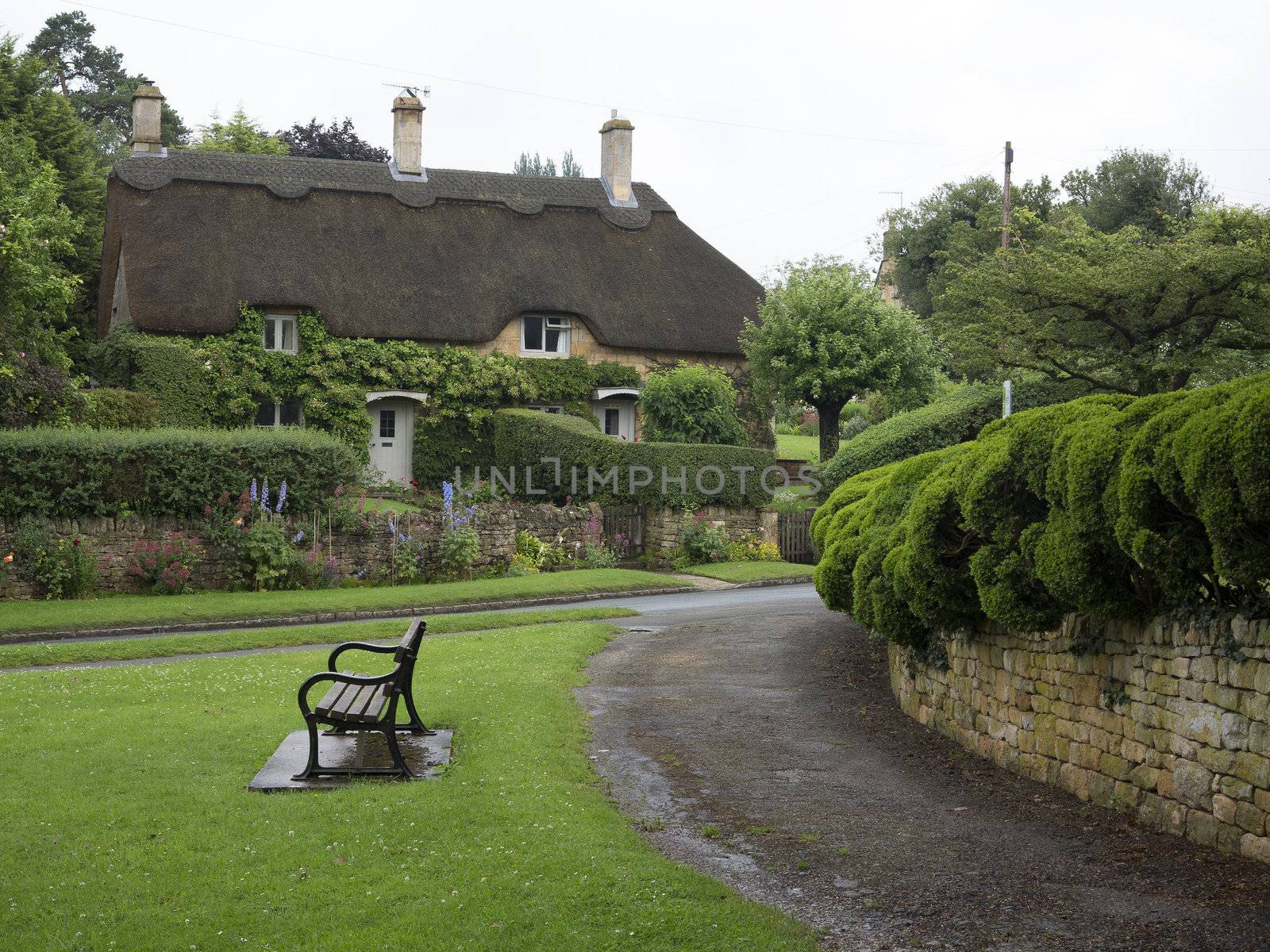 Beautiful old cottage with thatched roof and great hedges in the village of Chipping Campden, Cotswold, United Kingdom.