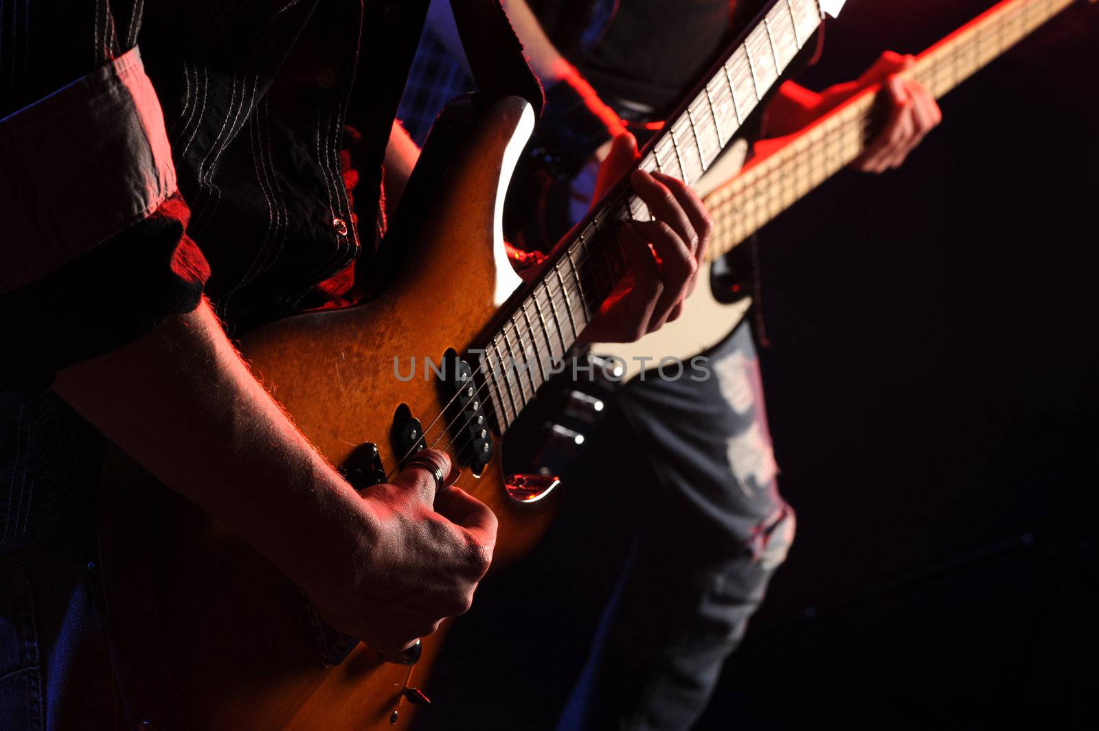 rock musicians playing at a live concert by stokkete