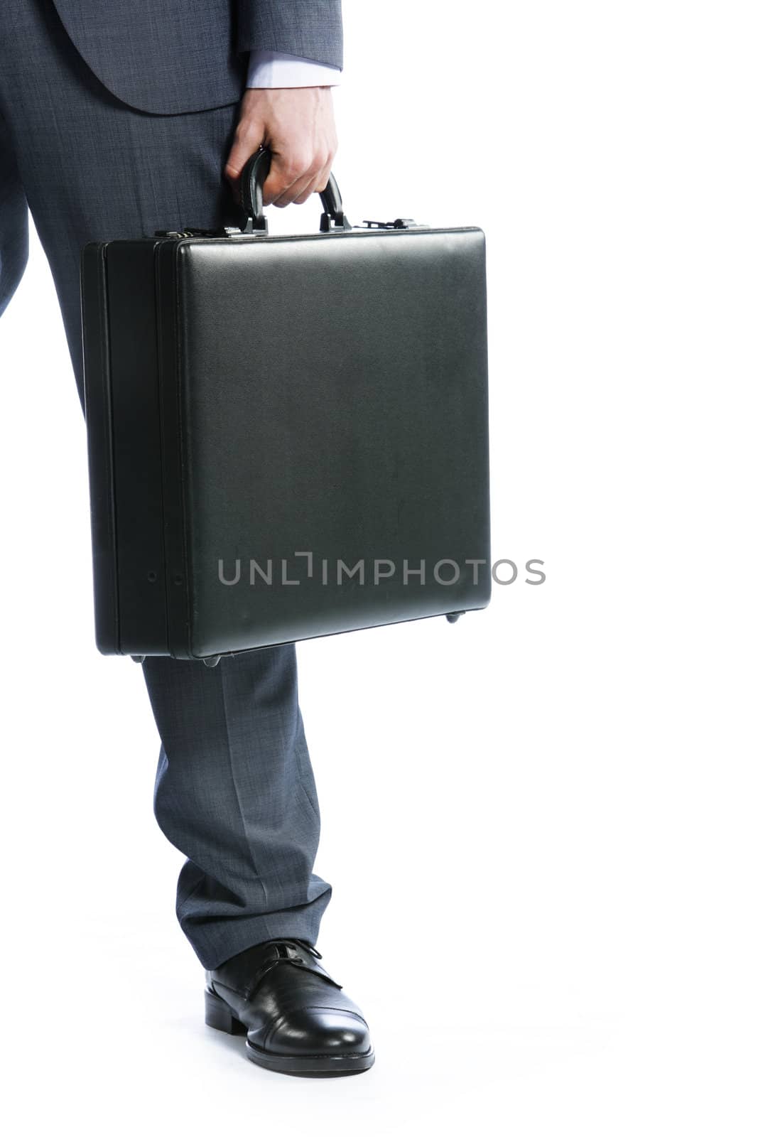 businessman with suitcase, close up by stokkete