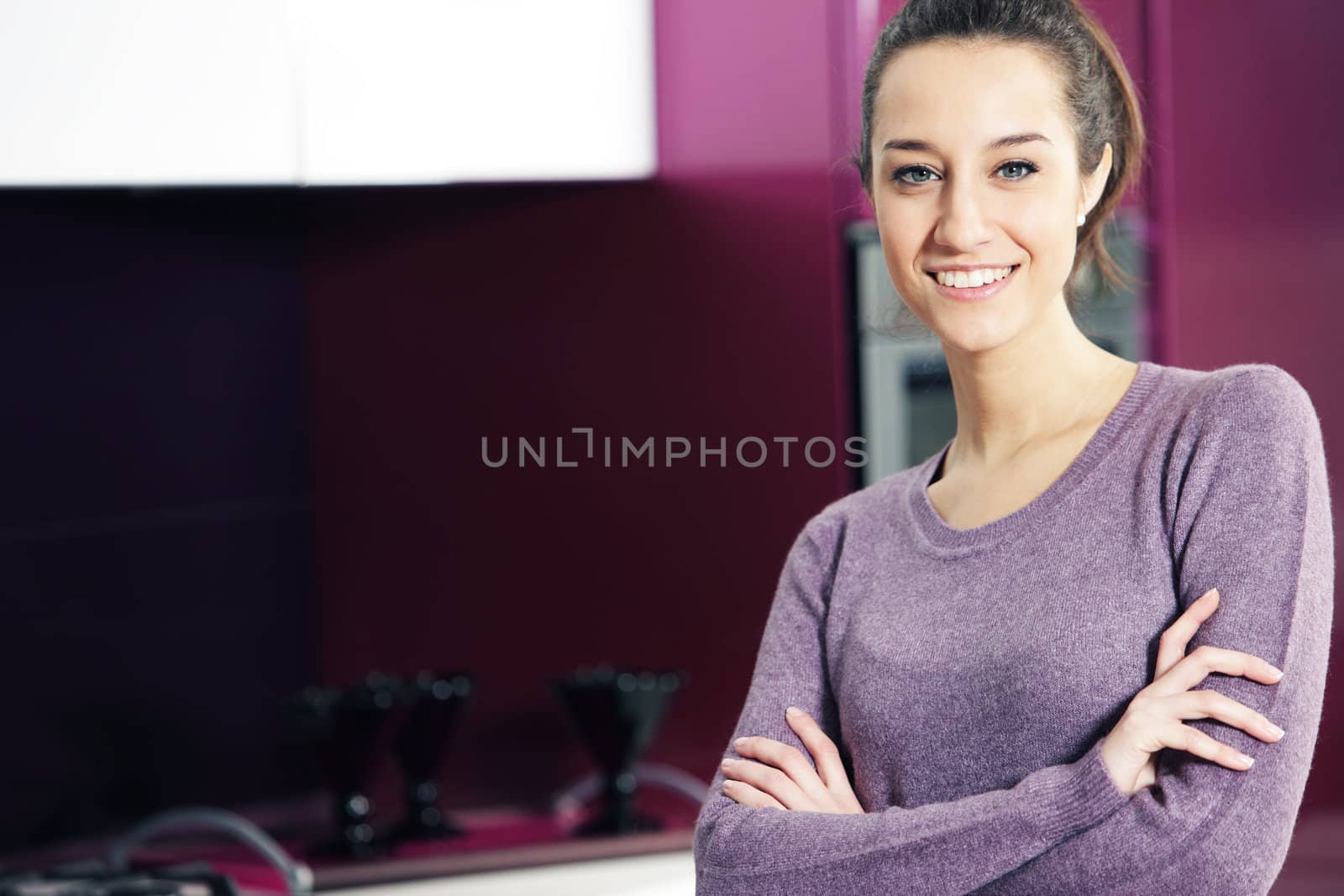 portrait of beautiful young woman in kitchen by stokkete