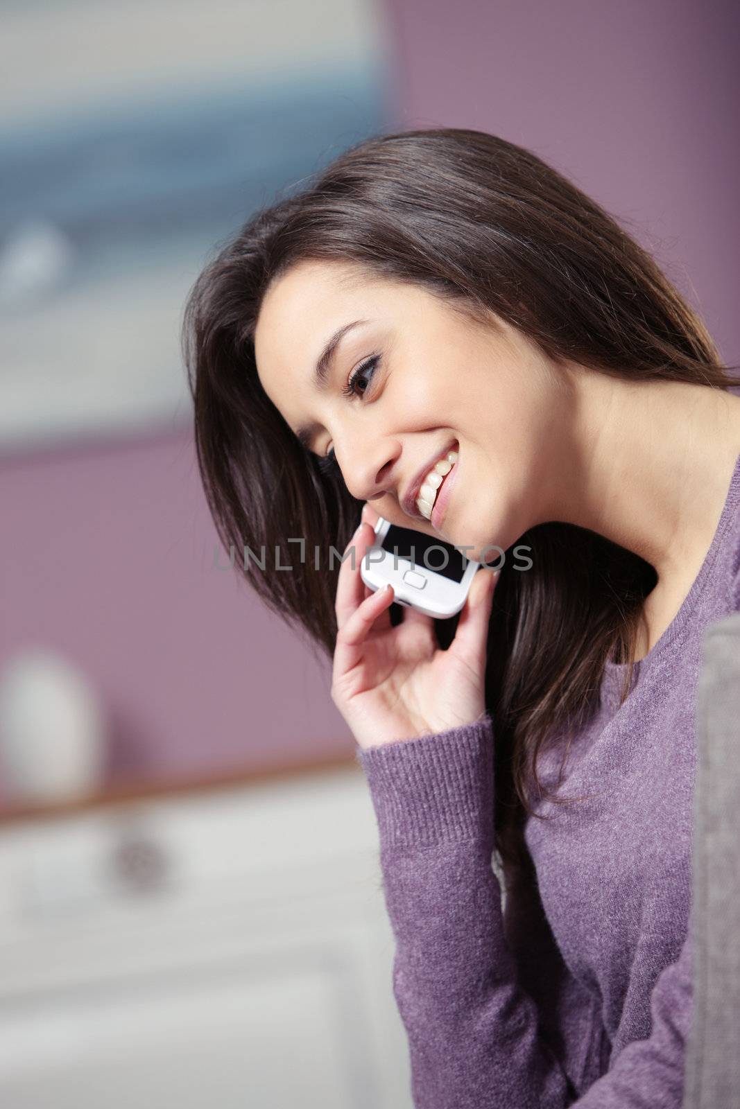 portrait of young smiling woman on phone
