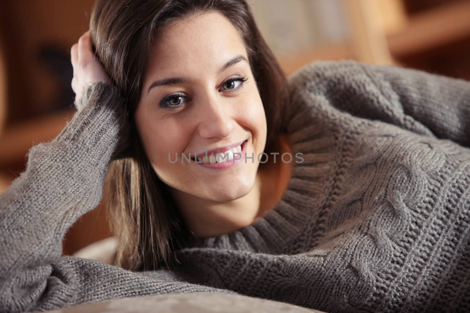 Portrait of a beautiful young woman on couch by stokkete
