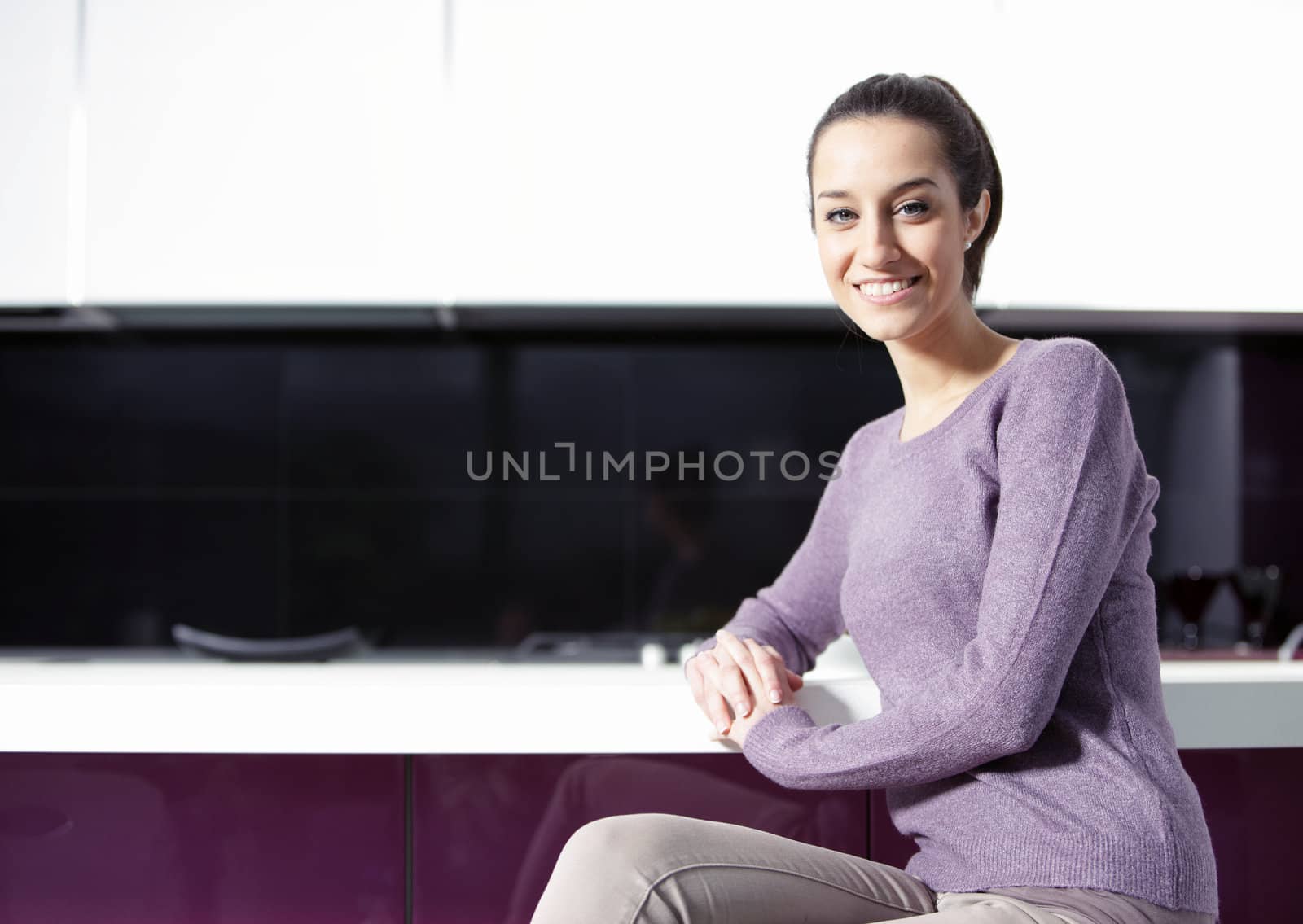 portrait of beautiful young woman in kitchen by stokkete