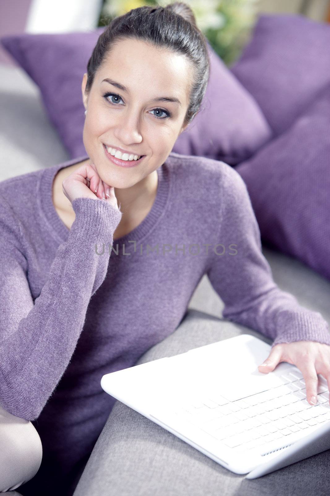 at home: young woman working on her laptop