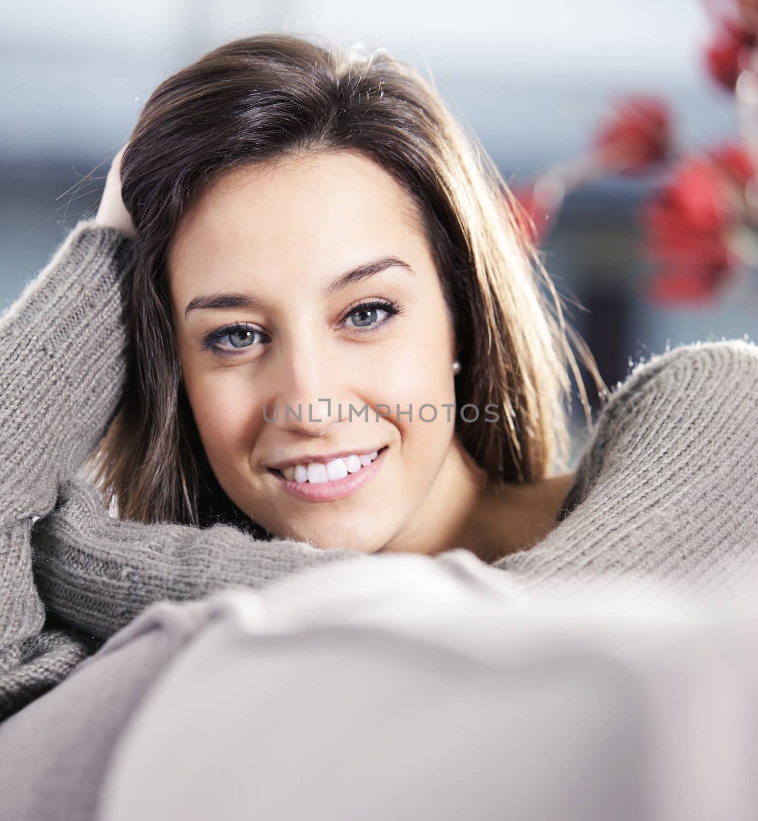 Portrait of a beautiful young woman on couch by stokkete