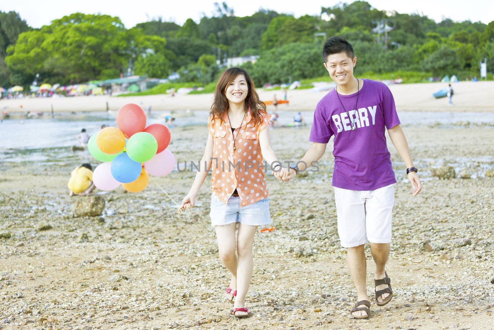 Happy asian couple at beach