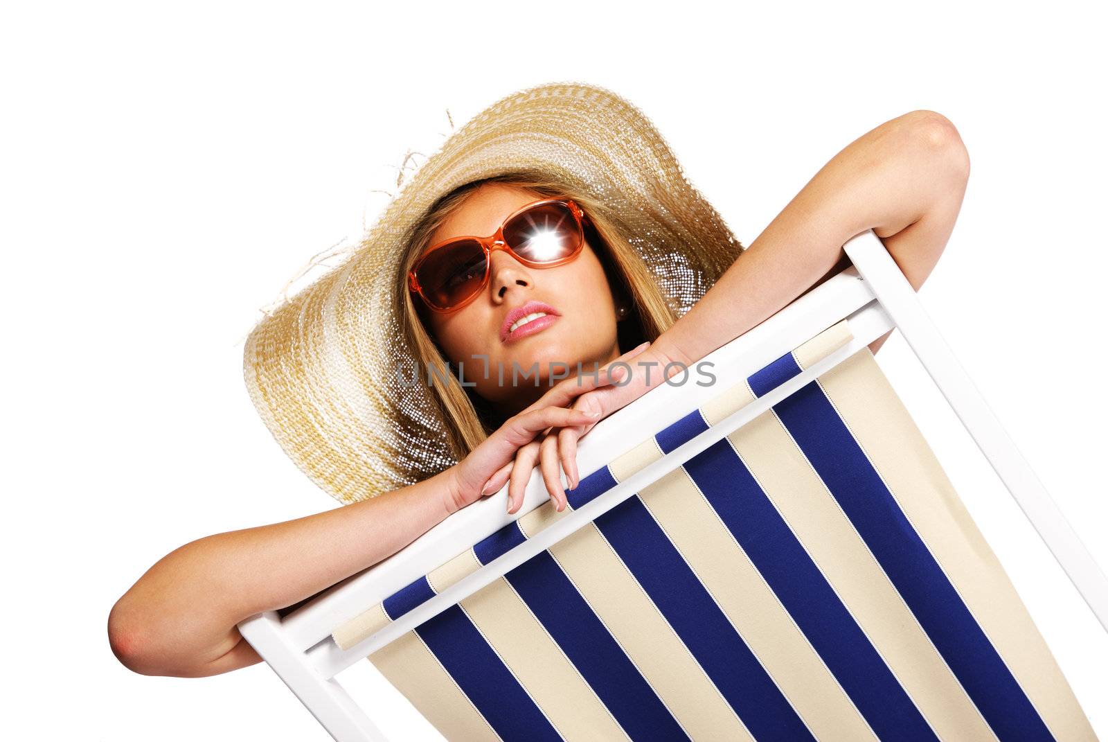 Beautiful young woman with sunglasses relaxing on beach chair isolated on white background