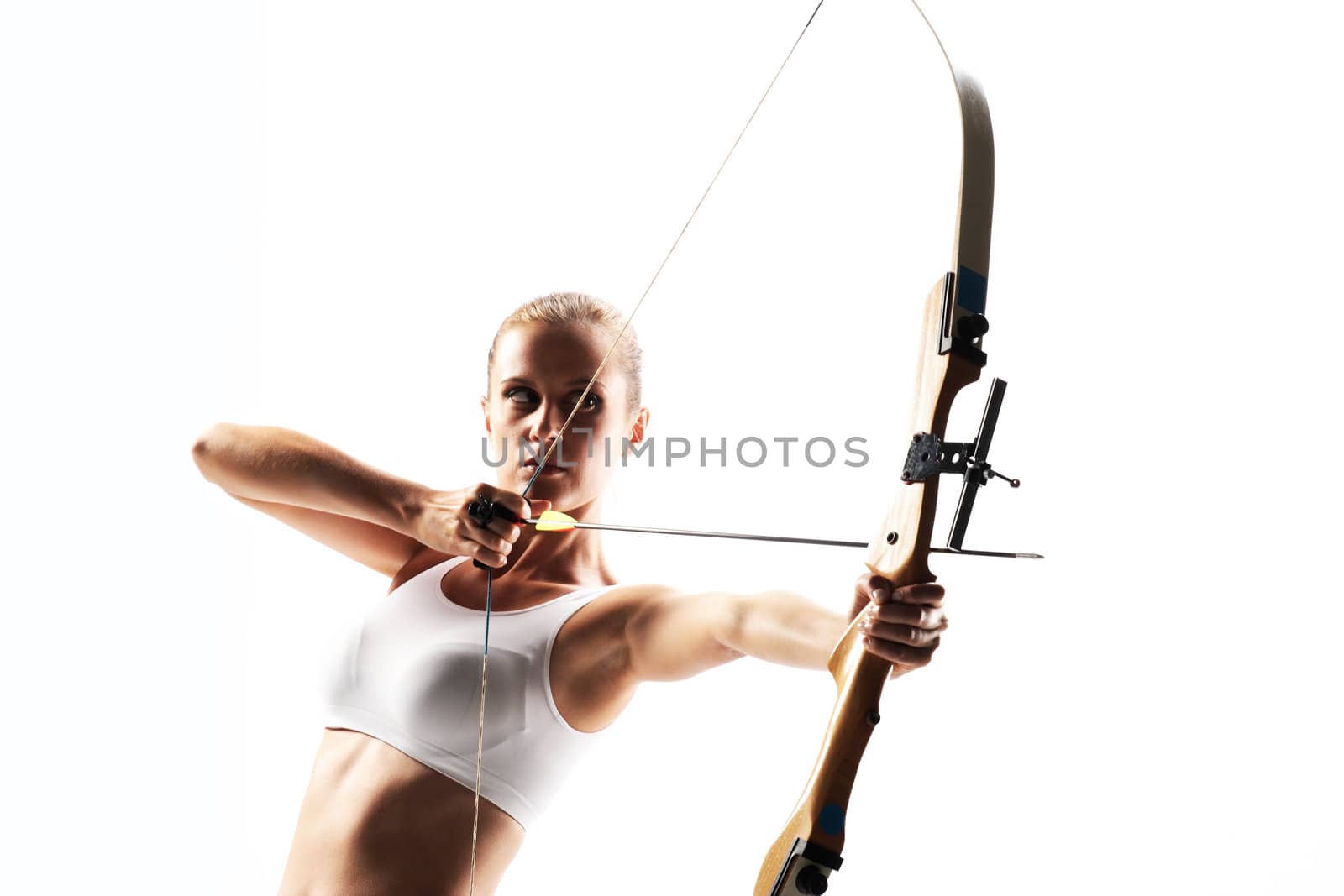 Beautiful woman aiming with bow and arrow