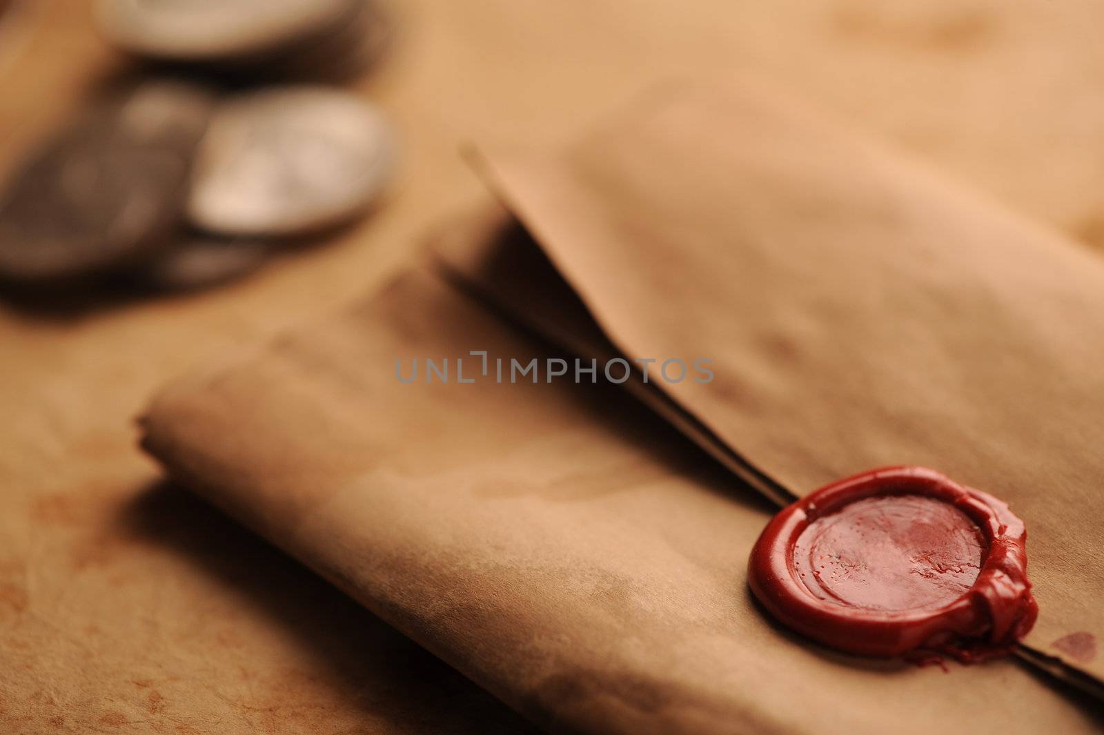 wax seal on a grunge paper, old coins on background