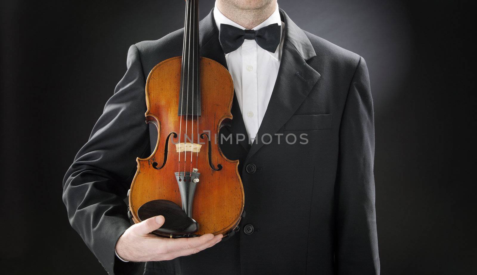 an elegant violinist with his violin by stokkete