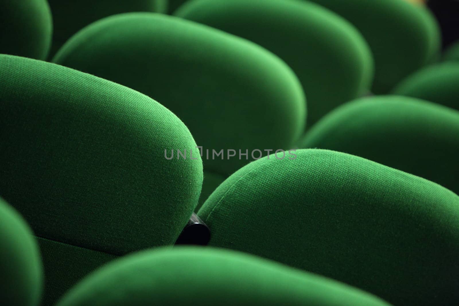 Closeup picture of chairs in empty cinema auditorium