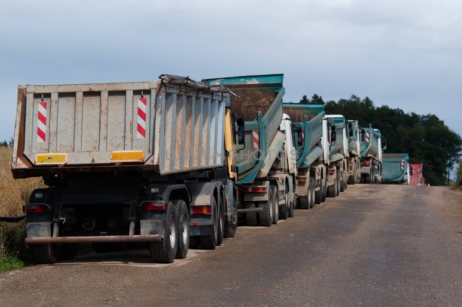 Row of Dump Trucks and Earth Moving Equipment at a Highway Construction Site in Germany