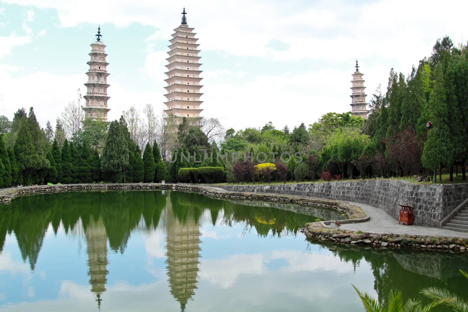 Three pagodas and water with reflection in Dali, China