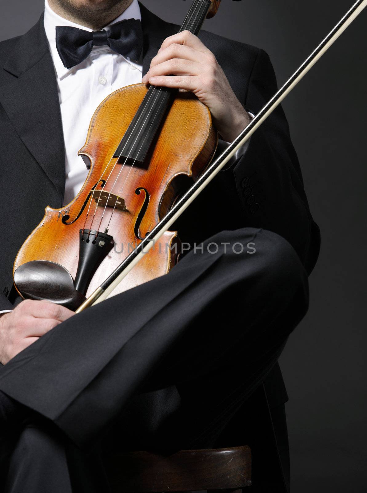 an elegant violinist with his violin by stokkete